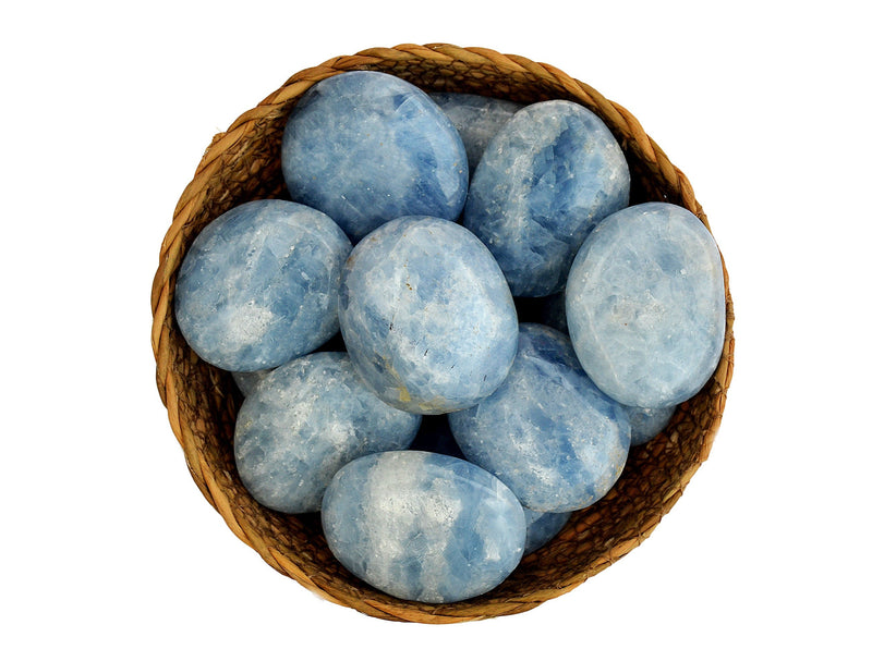 Several blue calcite palm stones 40mm-70mm inside a basket on white background