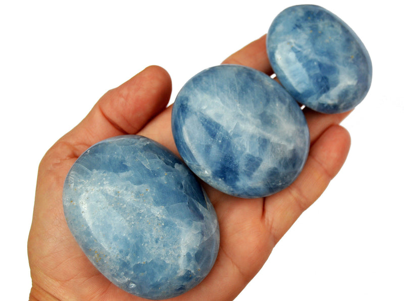 Three blue calcite palm stone crystals 70mm-40mm on hand