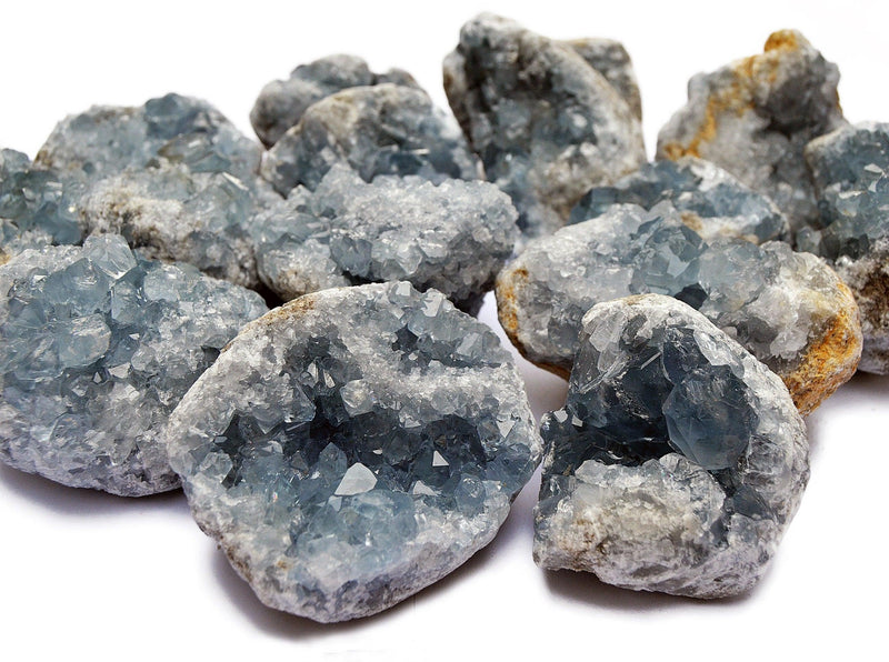 Some chunky celestite druzy crystals 70mm - 80mm on white background
