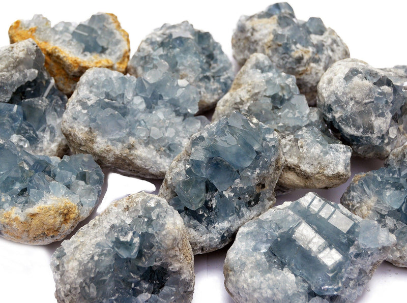 Blue celcestite crystals geode 60mm - 70mm on white background