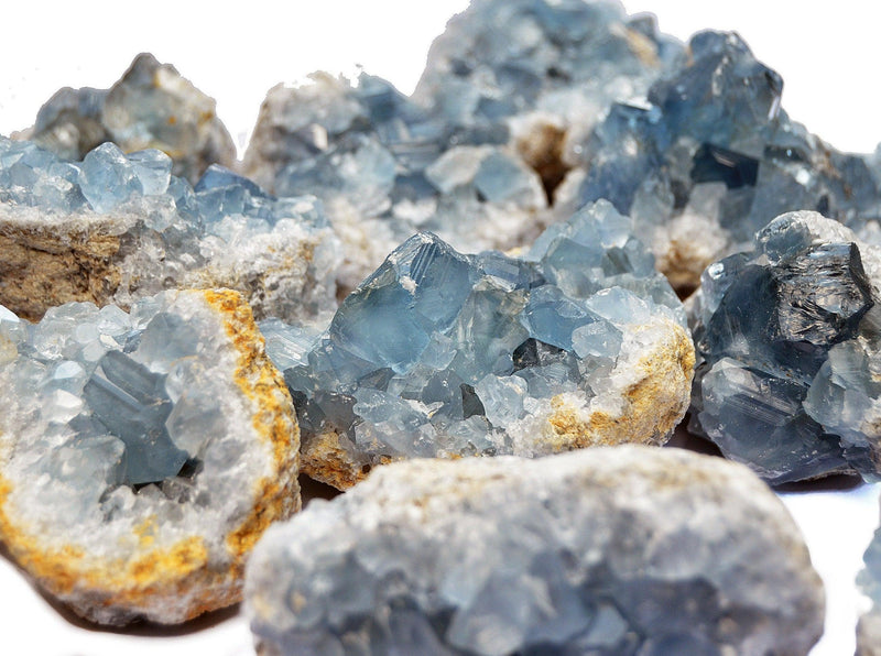 Some blue celcestite geode crystals 60mm - 70mm on white background