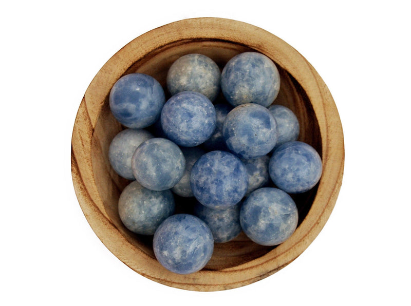 Several blue calcite mineral spheres 25mm-40mm inside a wood bowl