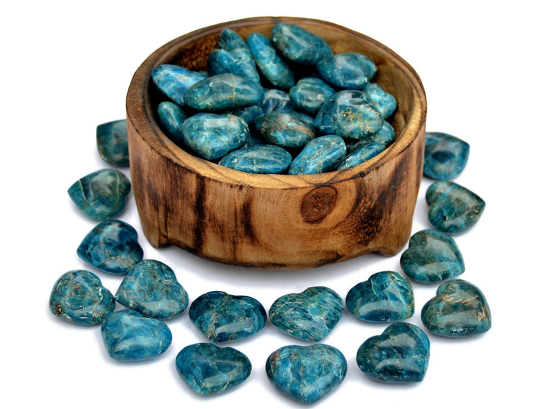Several blue aapatite heart stones 30mm inside a bowl with some hearts outside around