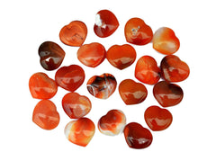 Several carnelian crystal hearts 30mm on white background