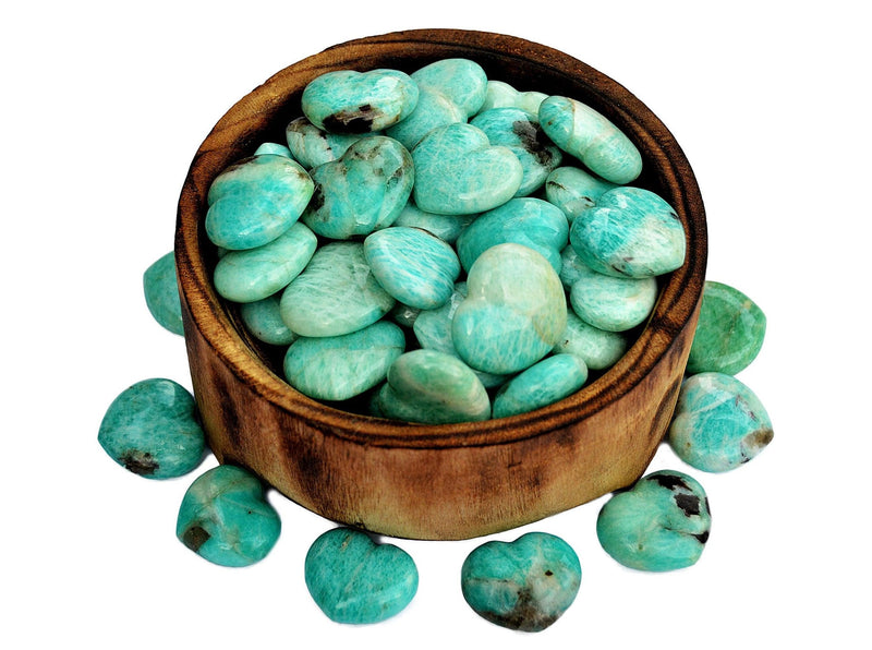 Several amazonite crystal hearts inside a bowl with some crystals 30mm around on white background