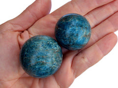 Two blue apatite crystal balls 40mm - 25mm on hand 