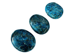 Three blue apatite palm stone crystals 70mm-40mm on white background