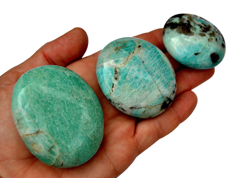 Three amazonite palm stone crystals 60mm-40mm on hand  with white background