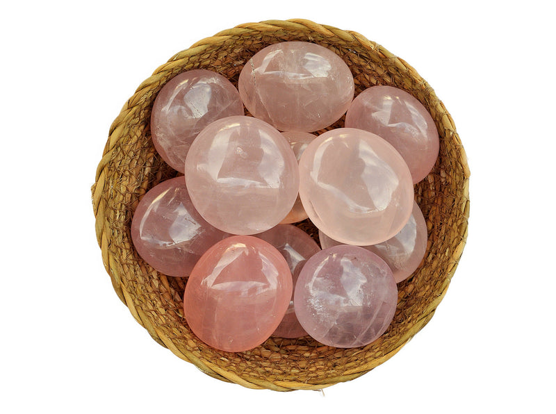 Several rose quartz palm stones 40mm-70mm inside a basket