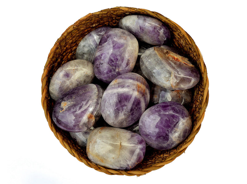 Several amethyst crystal palm stones 40mm - 60mm inside a basket