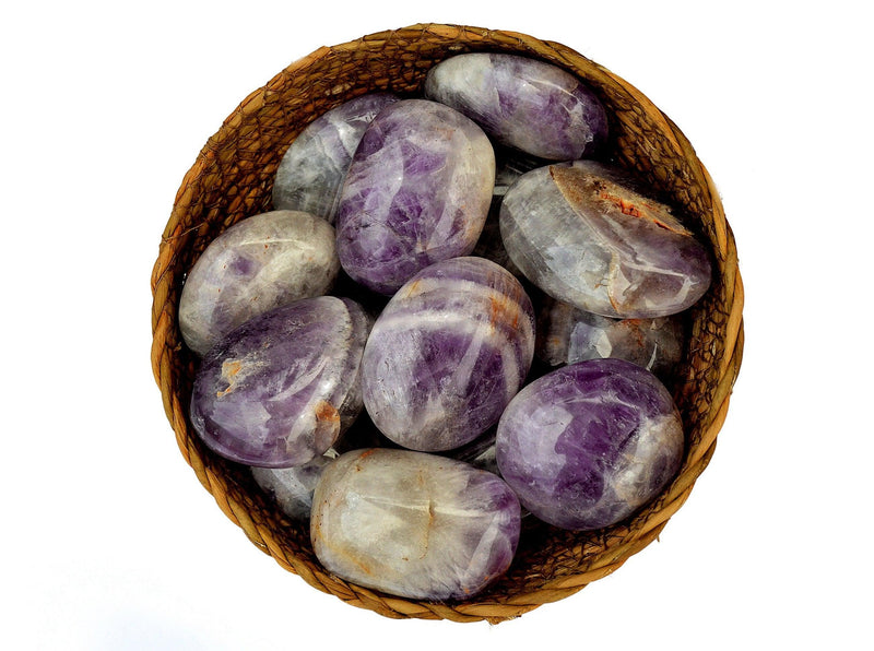 Several purple amethyst palm stones 40mm-60mm inside a basket