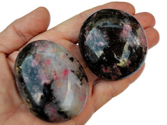 Two large rhodonite palm stones on hand