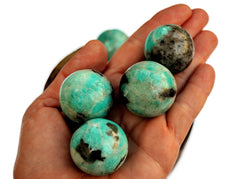 Some amazonite sphere stones 25mm-40mm on hand with white background