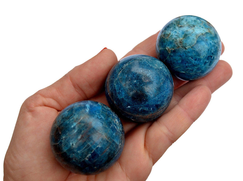 Three blue apatite crystal balls 40mm on hand 