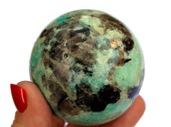 One amazonite sphere stone 55mm on hand with white background