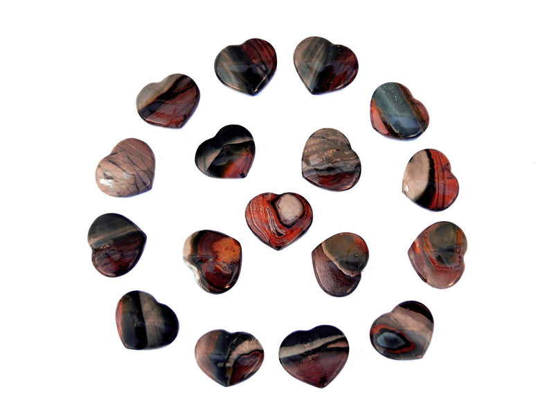 Several polychrome jasper crystal hearts 30mm forming a circle on white background