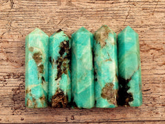 Five amazonite crystal tower points 95mm on wood table