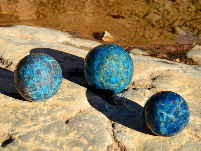 Three big blue apatite crystal spheres 70mm - 95mm on natural rock