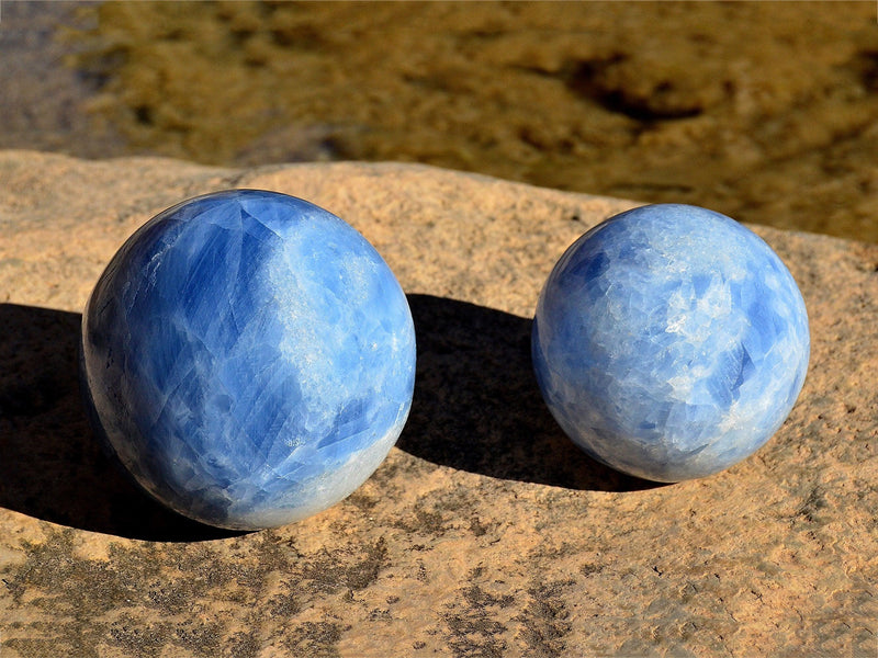 Two big blue calcite spheres on natural rock