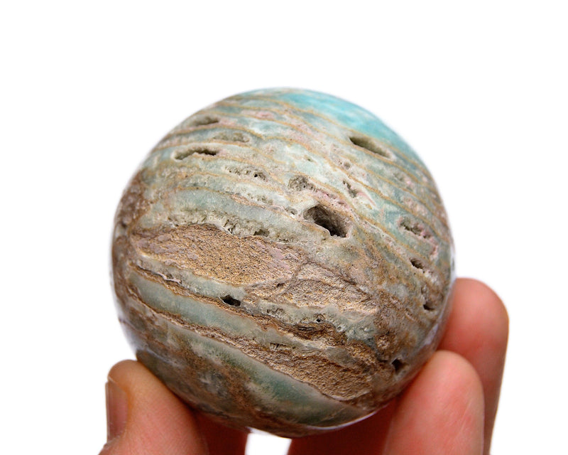 One blue aragonite crystal sphere 70mm on hand with white background
