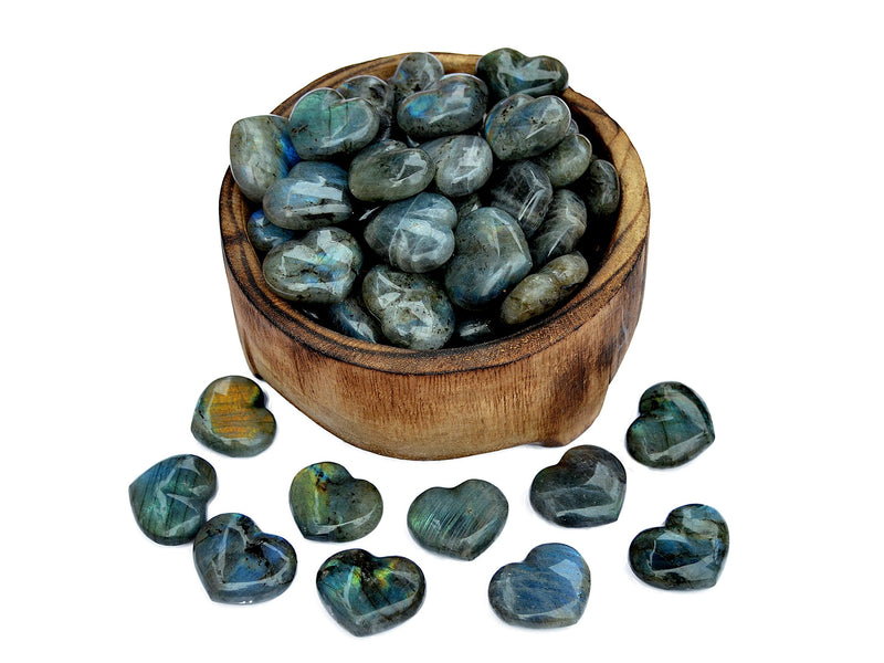 Several labradorite puffy heart crystals 30mm inside a bowl with some stones outside