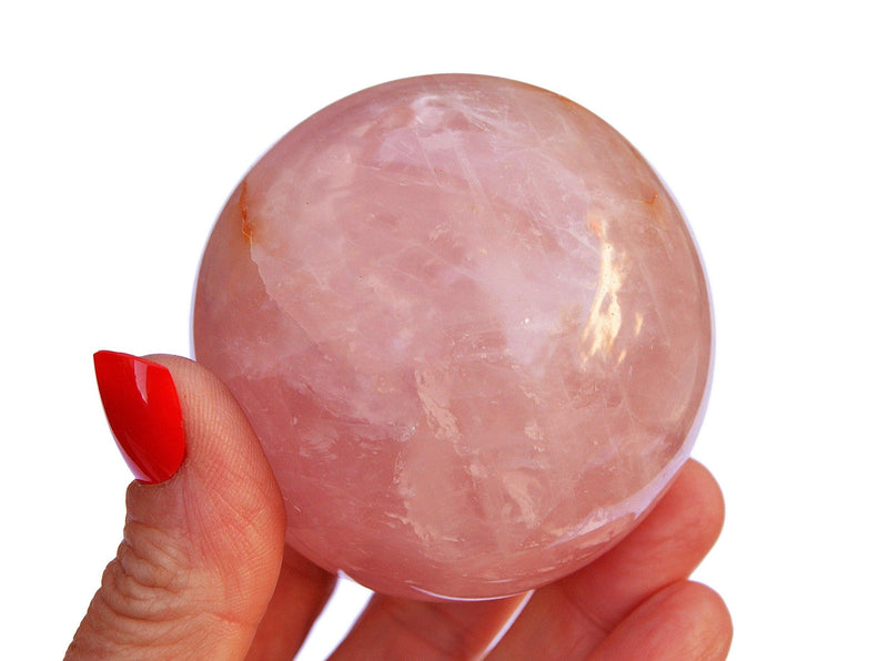 Large natural rose quartz crystal sphere 60mm on hand
